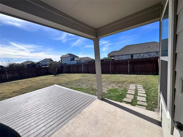 a view of wooden house with a yard