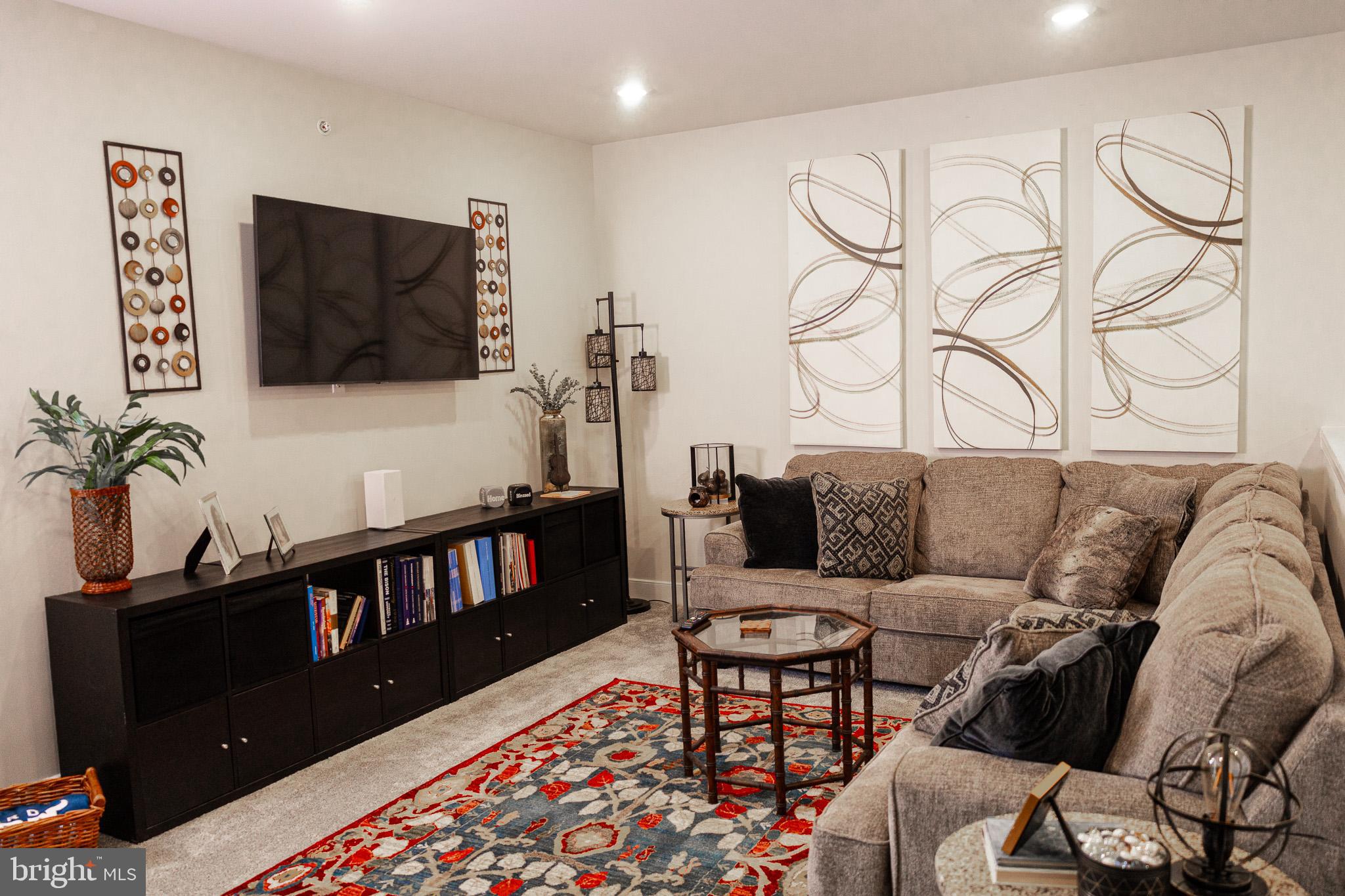 12207 American Chestnut Road Bowie, MD 20720 - Photo 14 of 19 a living room with furniture and a flat screen tv