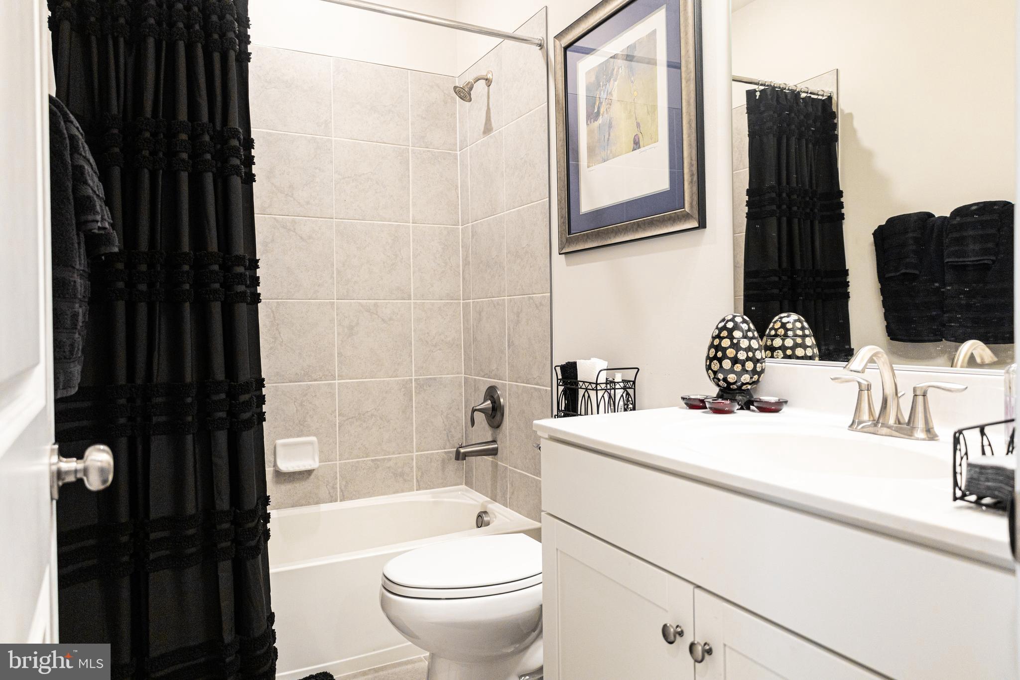 12207 American Chestnut Road Bowie, MD 20720 - Photo 15 of 19 a bathroom with a sink toilet and shower