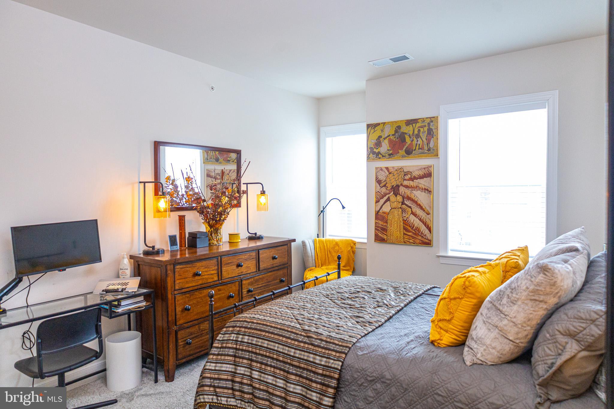 12207 American Chestnut Road Bowie, MD 20720 - Photo 16 of 19 a bedroom with a bed and flat screen tv