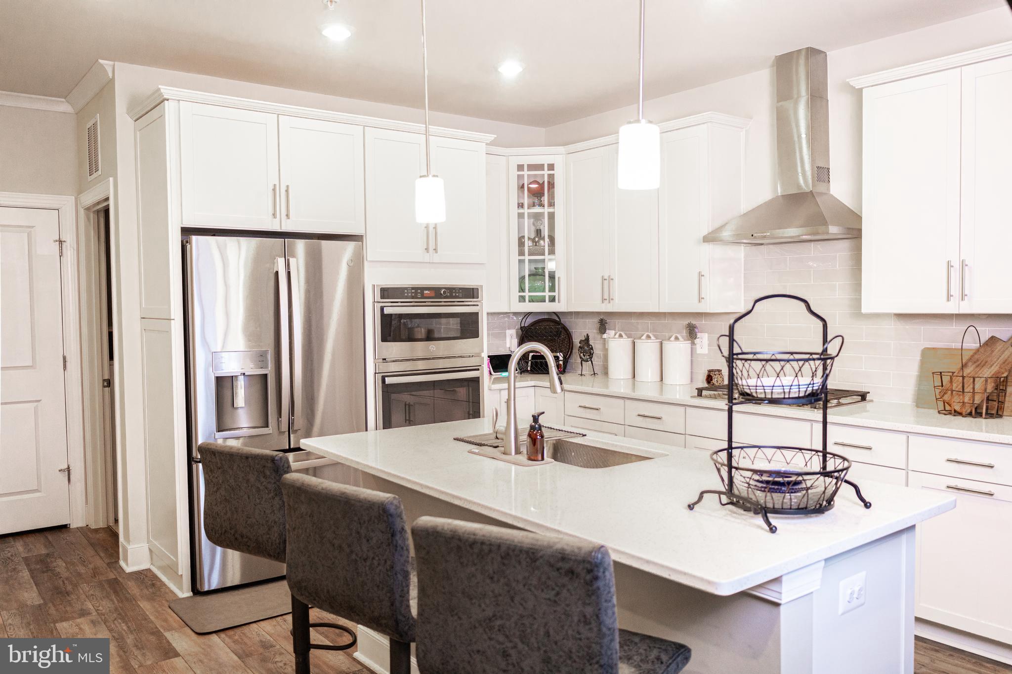 12207 American Chestnut Road Bowie, MD 20720 - Photo 7 of 19 a kitchen with stainless steel appliances a sink and a refrigerator