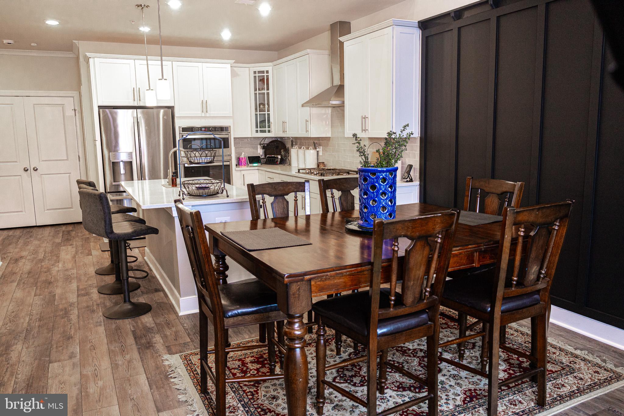 12207 American Chestnut Road Bowie, MD 20720 - Photo 8 of 19 a view of a dining room with furniture