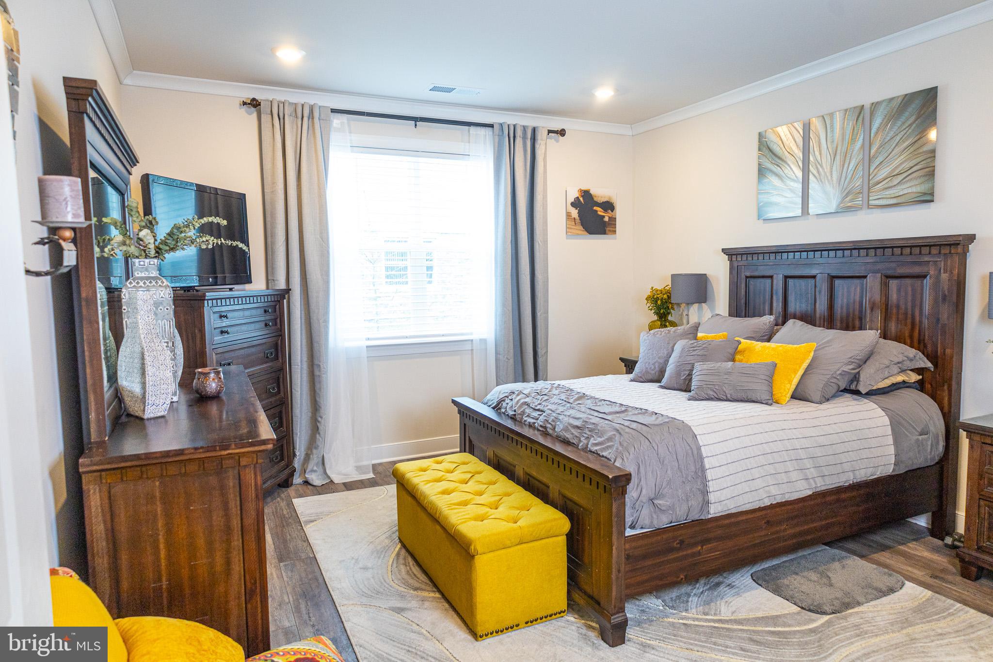 12207 American Chestnut Road Bowie, MD 20720 - Photo 10 of 19 a bedroom with a bed and wooden floor