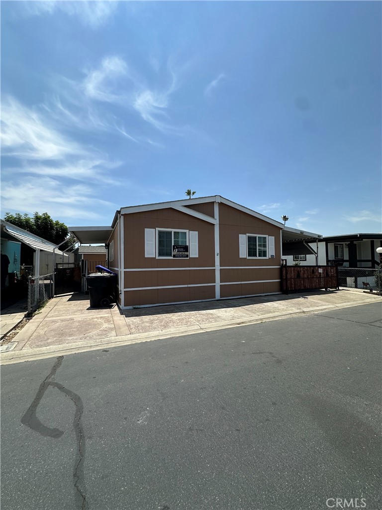 3825 Crestmore Road, Unit 414 Riverside, CA 92509 - Photo 3 of 31 a front view of a house with a yard