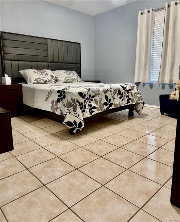 303 South Avasolo Street Rio Grande City, TX 78582 - Photo 5 of 5 a bedroom with a bed and a window in the corner