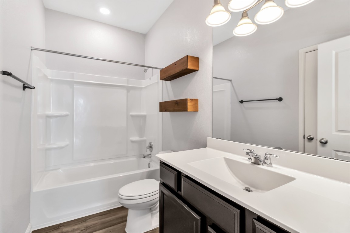 105 Bell Rings Drive Jarrell, TX 76537 - Photo 18 of 22 a bathroom with a sink a toilet and shower
