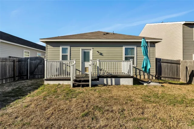a backyard of a house with wooden fence