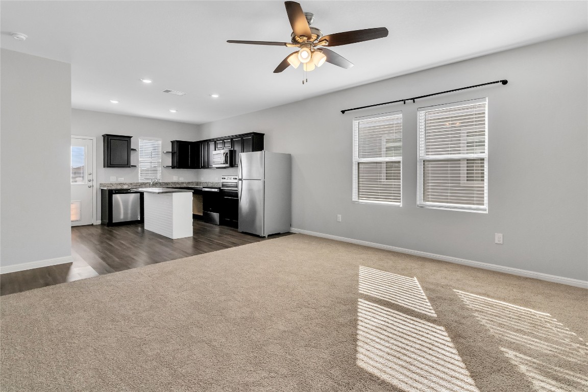 105 Bell Rings Drive Jarrell, TX 76537 - Photo 22 of 22 a open kitchen with stainless steel appliances granite countertop a refrigerator a sink dishwasher a stove with white cabinets