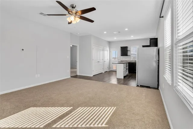 a open kitchen with stainless steel appliances granite countertop a refrigerator a sink dishwasher a stove with white cabinets