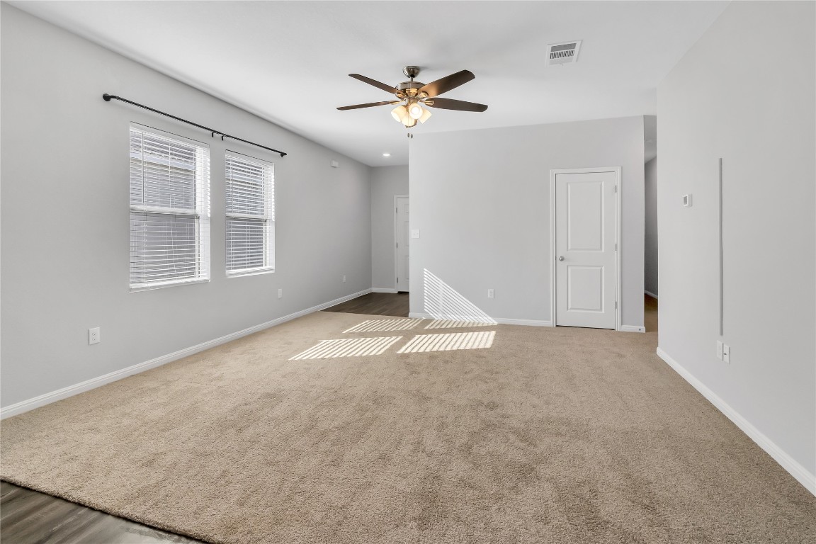 105 Bell Rings Drive Jarrell, TX 76537 - Photo 5 of 22 an empty room with a ceiling fan and window