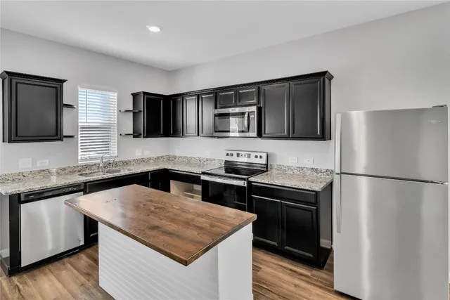 an empty room with a ceiling fan and window