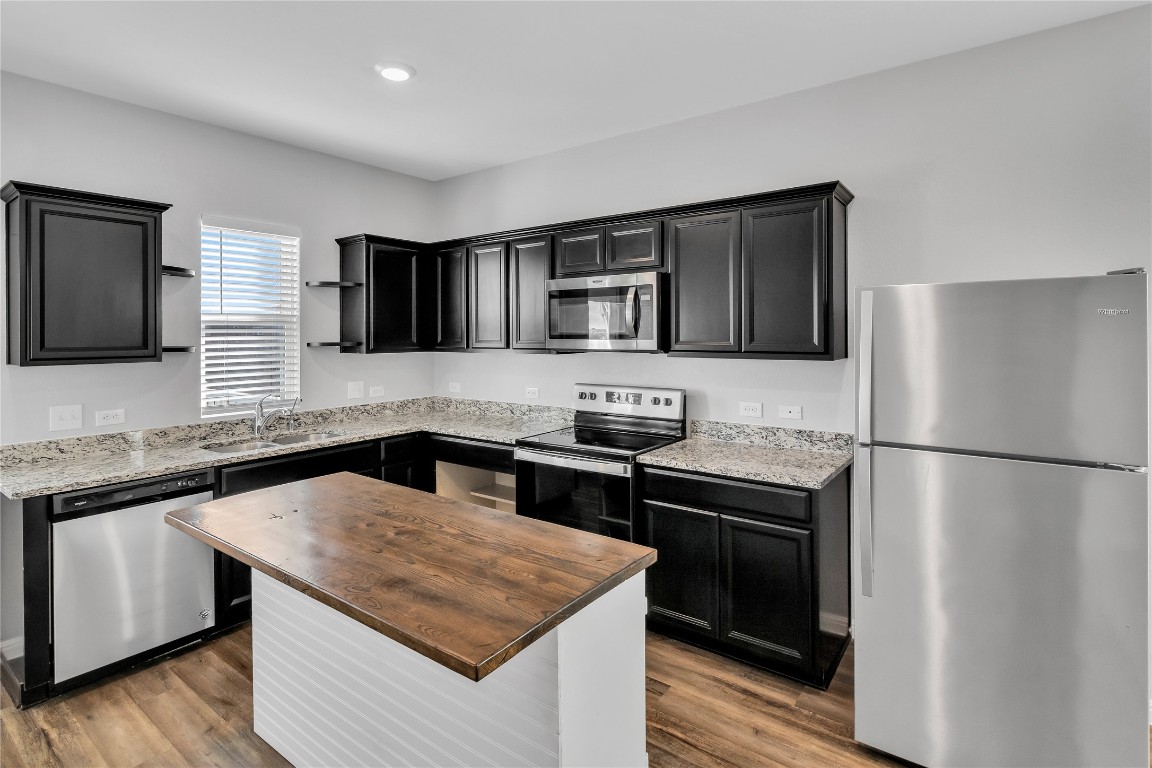 105 Bell Rings Drive Jarrell, TX 76537 - Photo 6 of 22 a kitchen with a stove sink and refrigerator