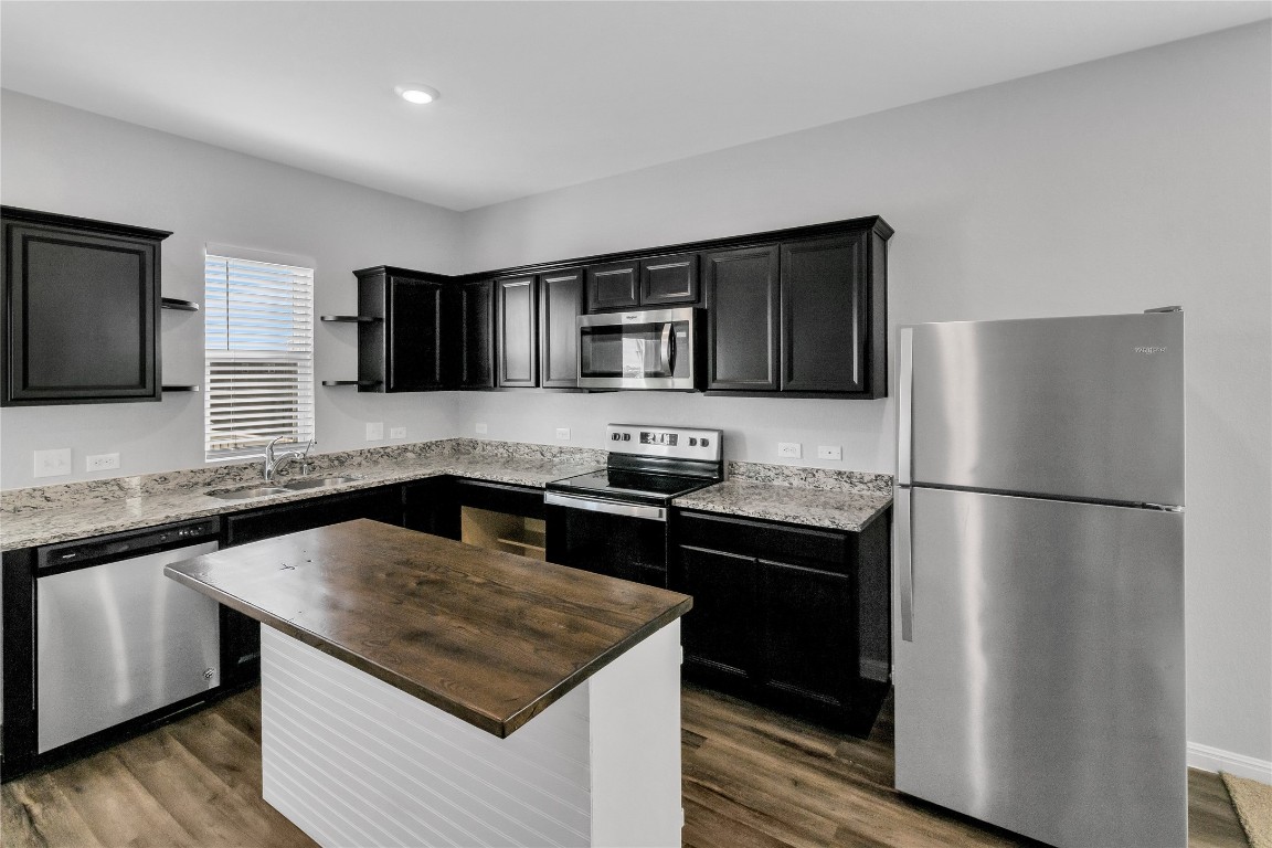 105 Bell Rings Drive Jarrell, TX 76537 - Photo 7 of 22 a kitchen with a refrigerator sink and microwave