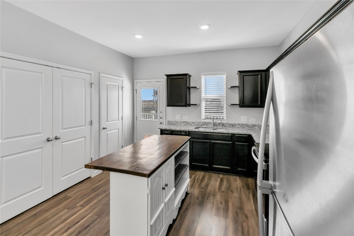 105 Bell Rings Drive Jarrell, TX 76537 - Photo 8 of 22 a kitchen with granite countertop a sink stove and refrigerator