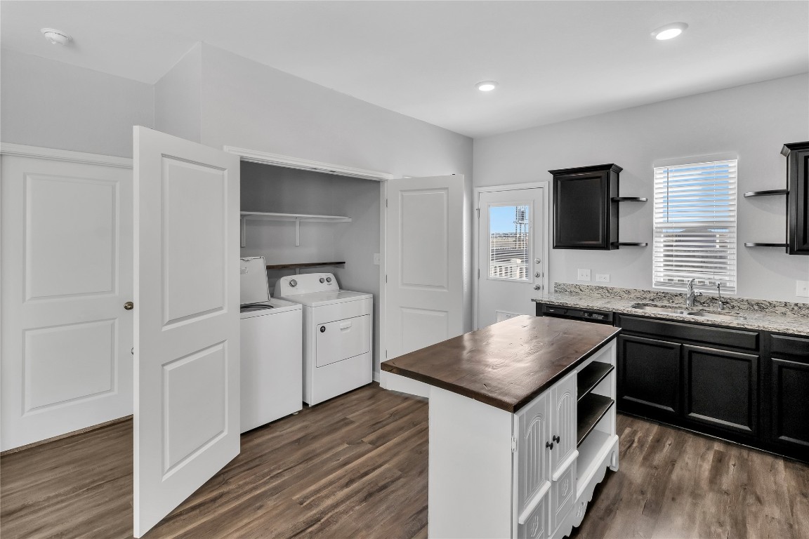 105 Bell Rings Drive Jarrell, TX 76537 - Photo 9 of 22 a kitchen with granite countertop a sink stove and refrigerator