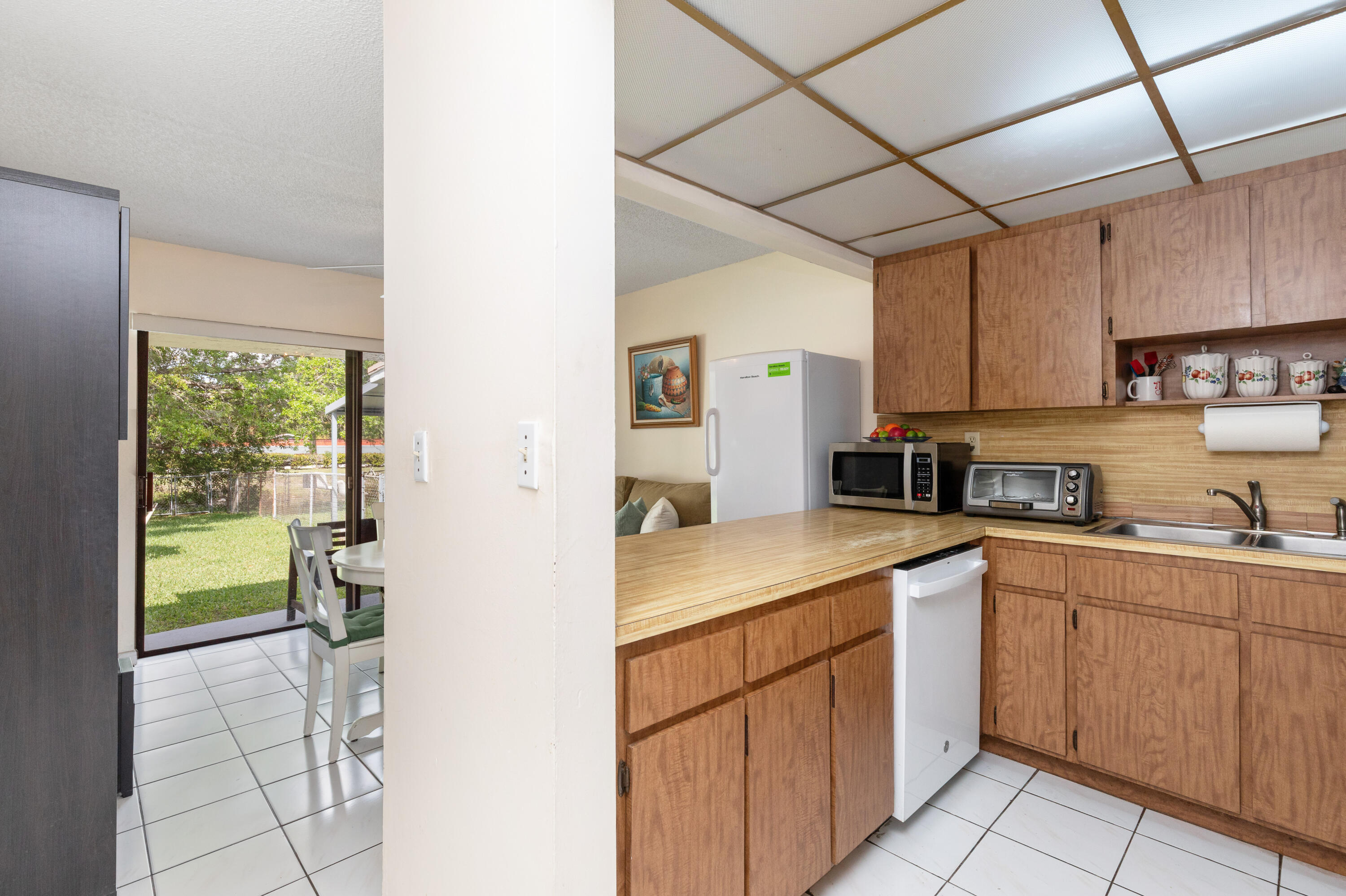 406 Southwest 96th Court, Unit 2 Miami, FL 33174 - Photo 13 of 38 a kitchen with a sink cabinets and window