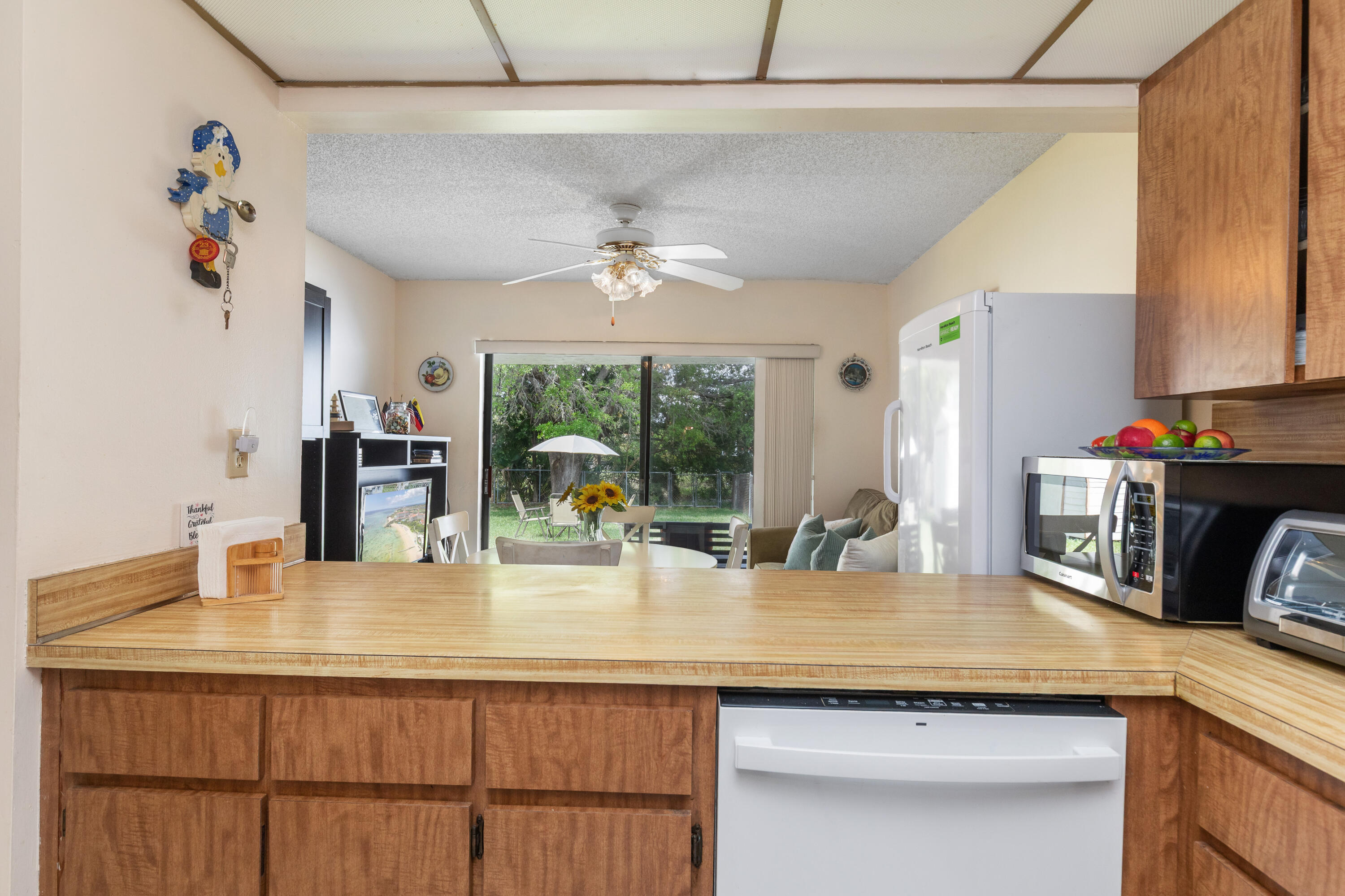 406 Southwest 96th Court, Unit 2 Miami, FL 33174 - Photo 14 of 38 a kitchen with kitchen island granite countertop a sink cabinets and window