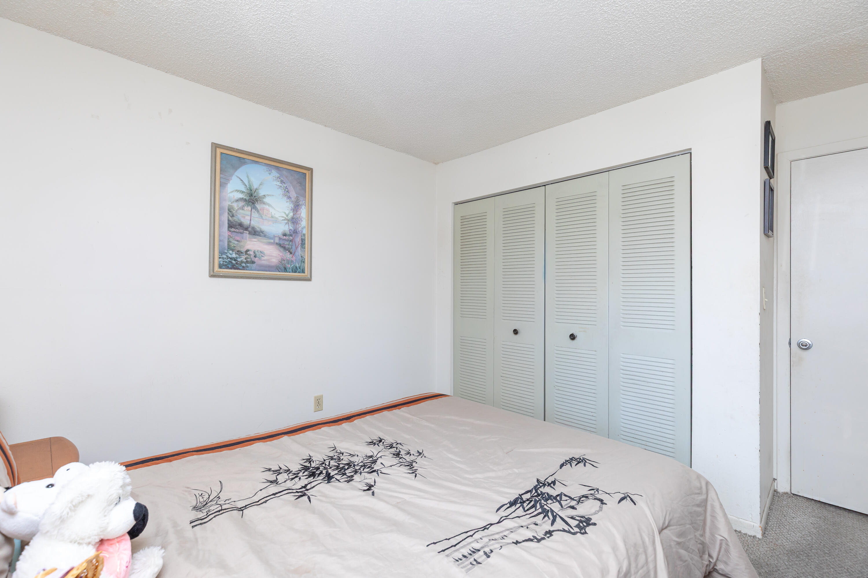 406 Southwest 96th Court, Unit 2 Miami, FL 33174 - Photo 27 of 38 a bedroom with a bed and hallway