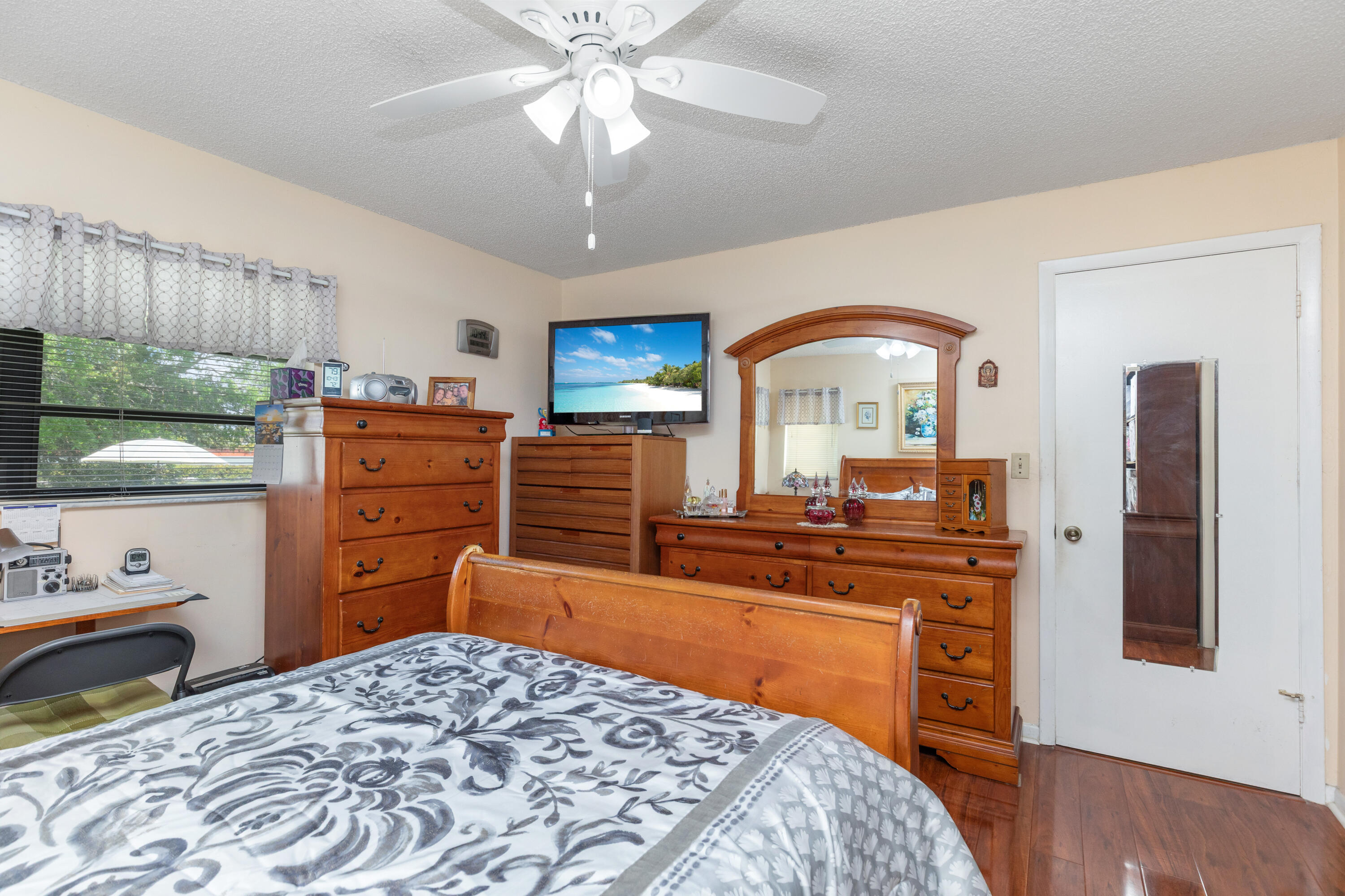 406 Southwest 96th Court, Unit 2 Miami, FL 33174 - Photo 32 of 38 a bedroom with a bed and a chandelier