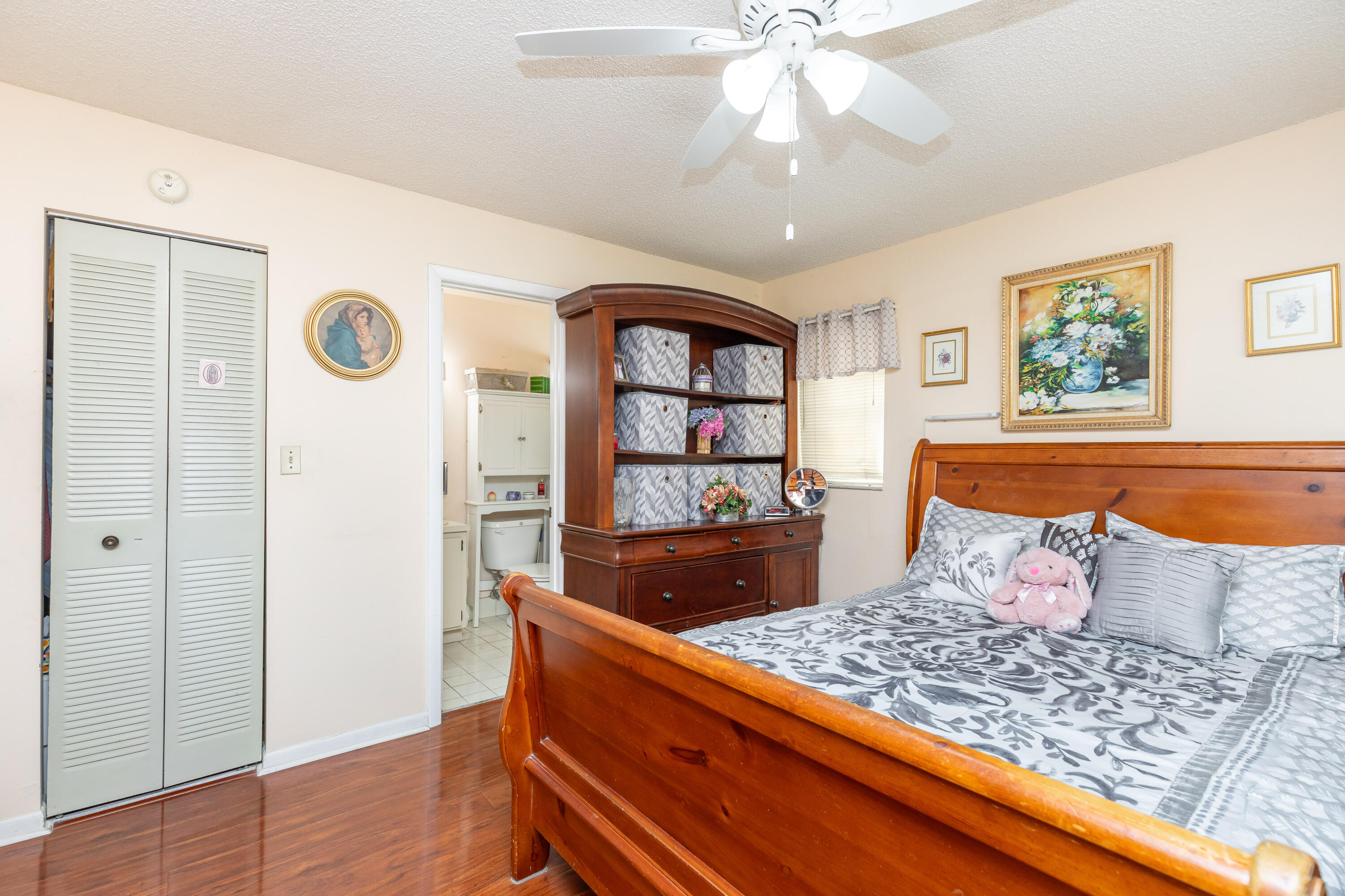406 Southwest 96th Court, Unit 2 Miami, FL 33174 - Photo 33 of 38 a bedroom with a bed and a dresser with wooden floor