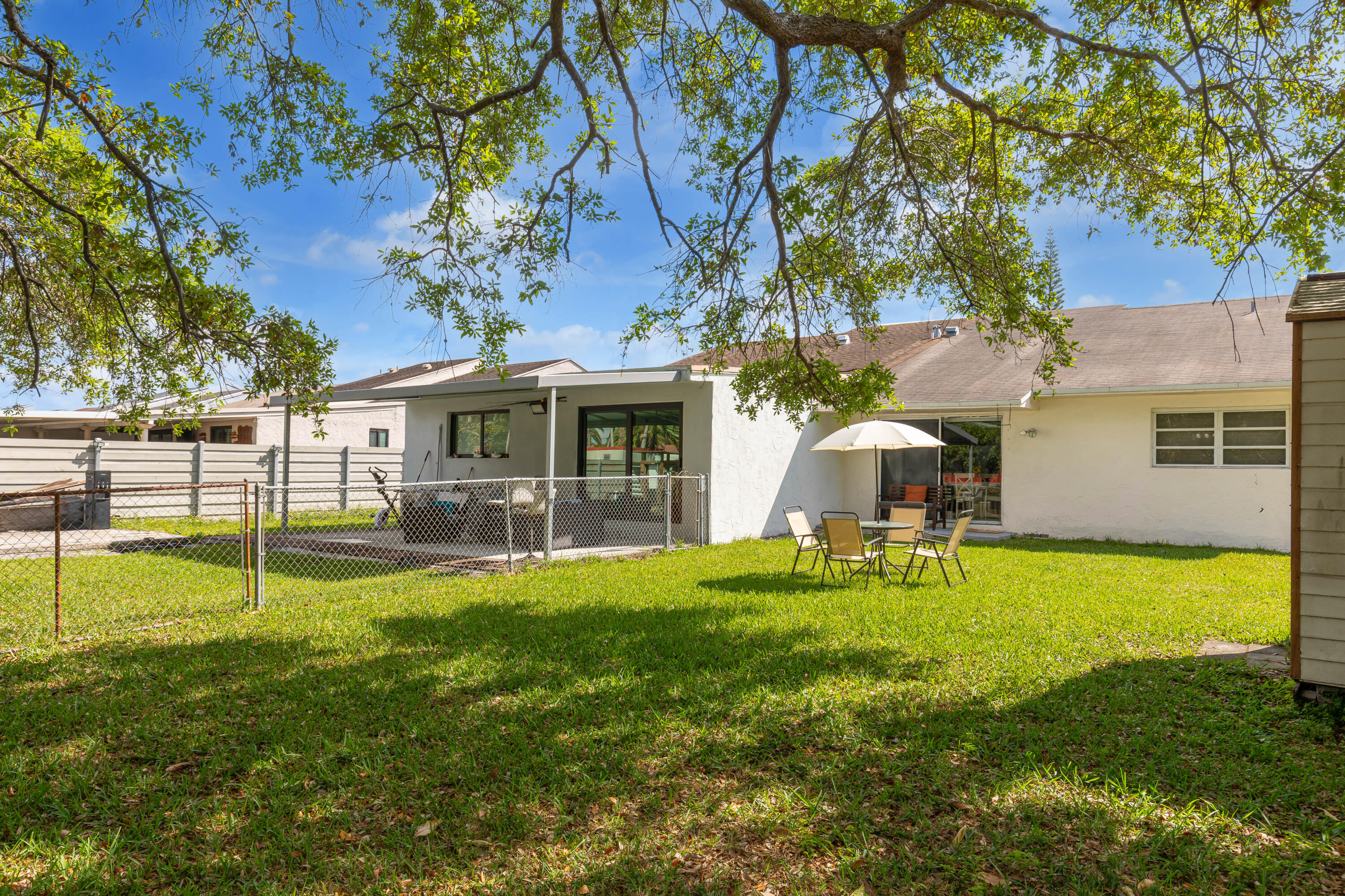 406 Southwest 96th Court, Unit 2 Miami, FL 33174 - Photo 35 of 38 a view of a house with a yard and a tree