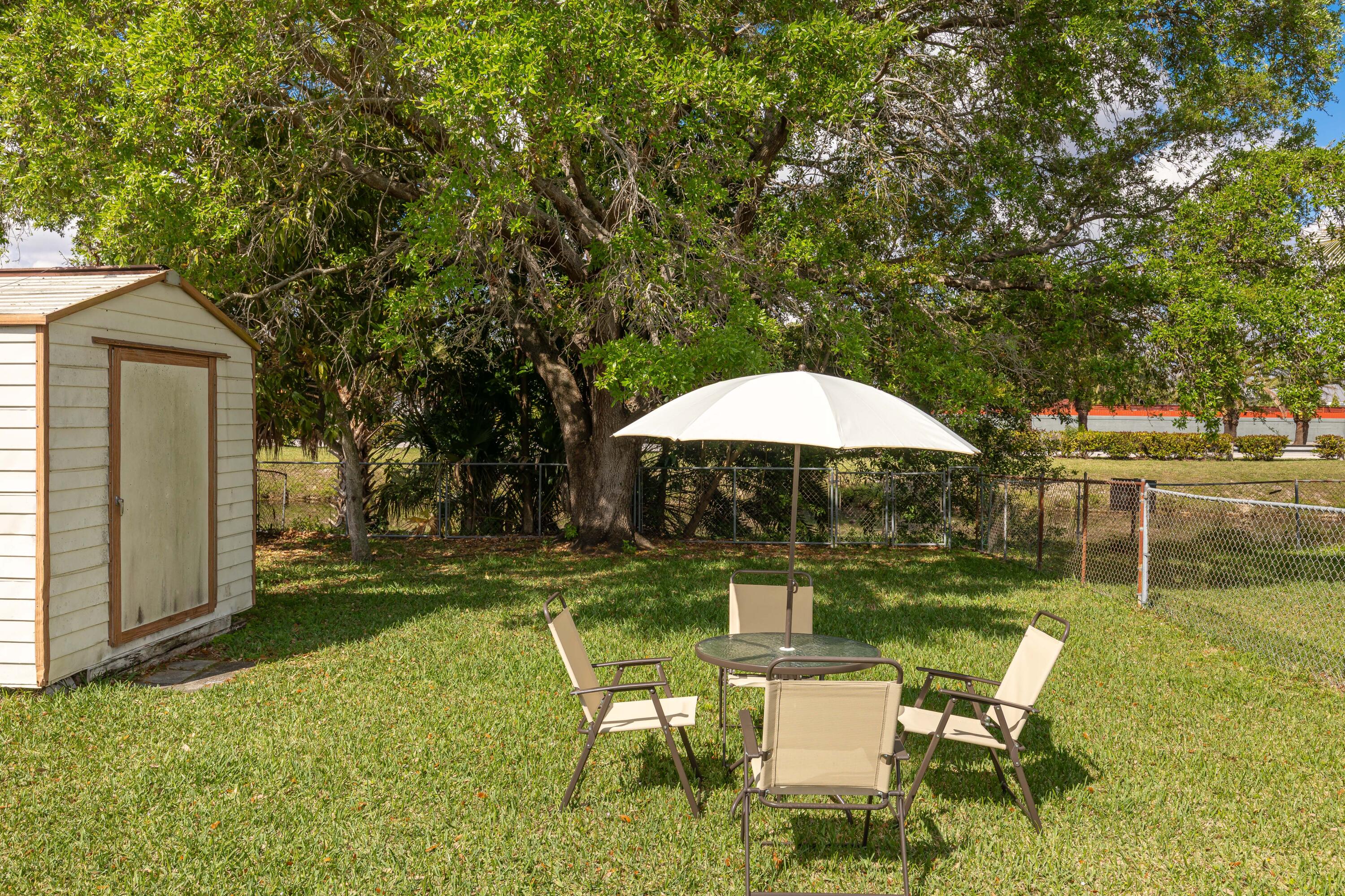 406 Southwest 96th Court, Unit 2 Miami, FL 33174 - Photo 38 of 38 a backyard of a house with table and chairs
