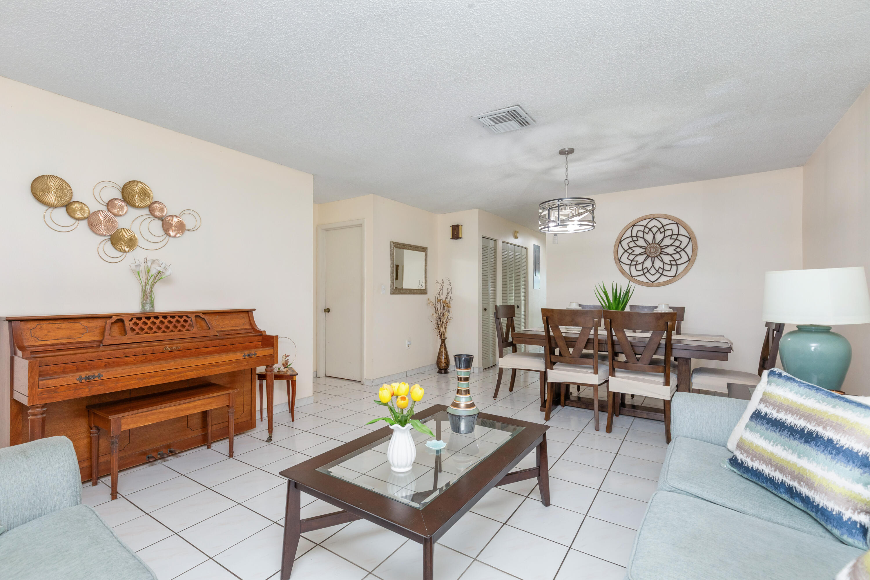 406 Southwest 96th Court, Unit 2 Miami, FL 33174 - Photo 4 of 38 a living room with furniture a rug and a chandelier