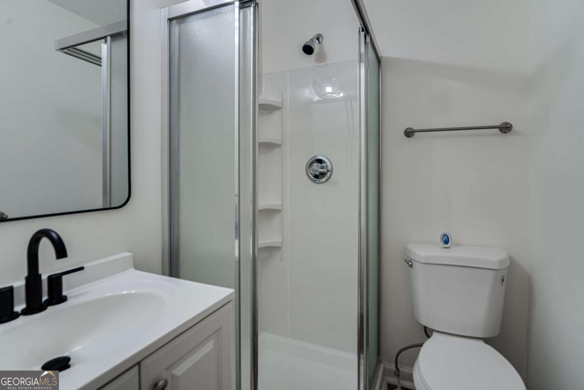 325 Camp Ground Road Griffin, GA 30223 - Photo 14 of 25 a bathroom with a toilet sink and shower