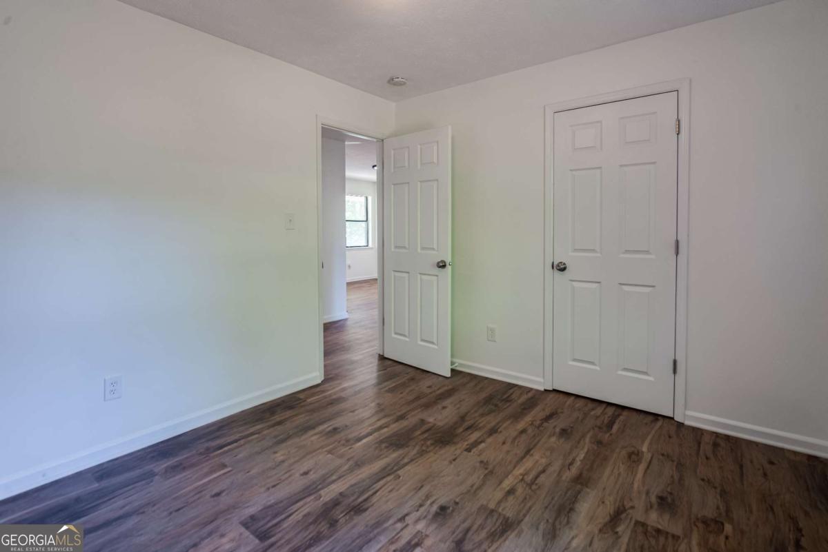 325 Camp Ground Road Griffin, GA 30223 - Photo 16 of 25 a view of an empty room with closet and wooden floor
