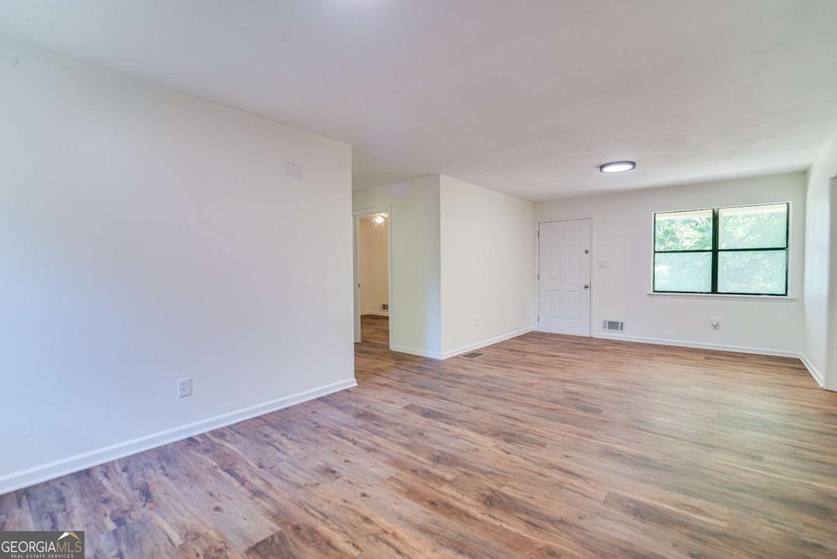 325 Camp Ground Road Griffin, GA 30223 - Photo 5 of 25 a view of empty room with wooden floor and fan
