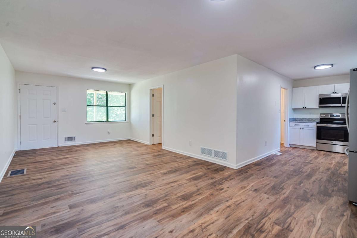 325 Camp Ground Road Griffin, GA 30223 - Photo 7 of 25 a view of a kitchen with wooden floor and a sink