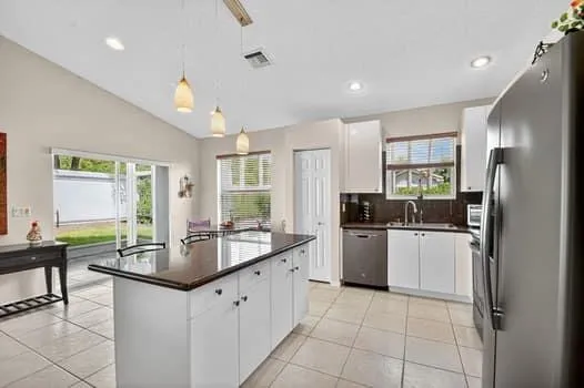 a kitchen with a sink stove and refrigerator
