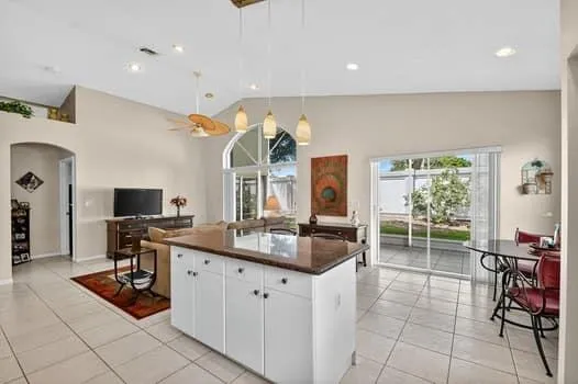 a kitchen with stainless steel appliances kitchen island granite countertop a sink and cabinets