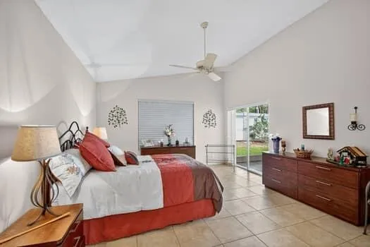 a bedroom with a bed a couch and dresser