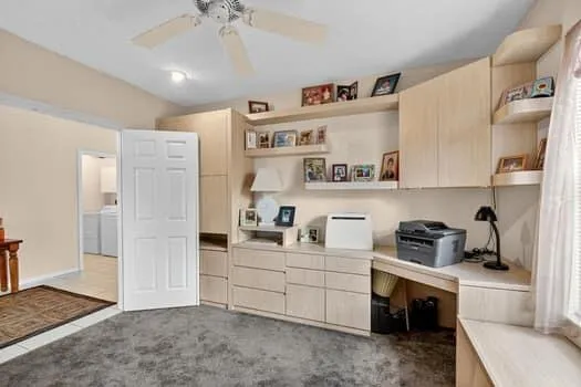 a kitchen with a refrigerator and white cabinets