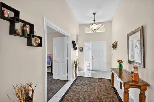 a view of a hallway with wooden floor and entryway