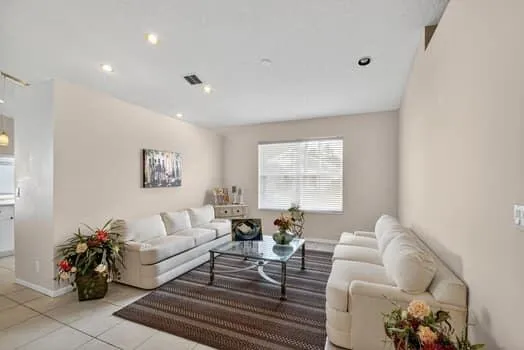 a living room with furniture and wooden floor
