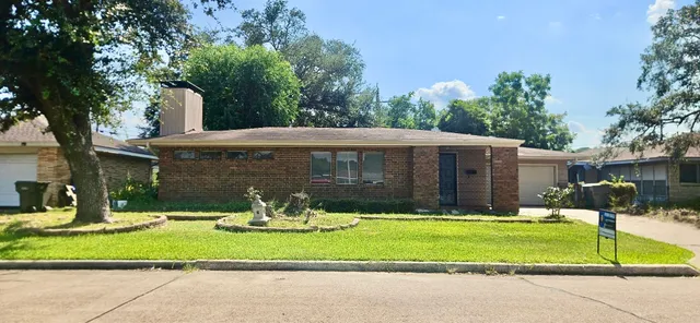 a front view of house with yard and trees