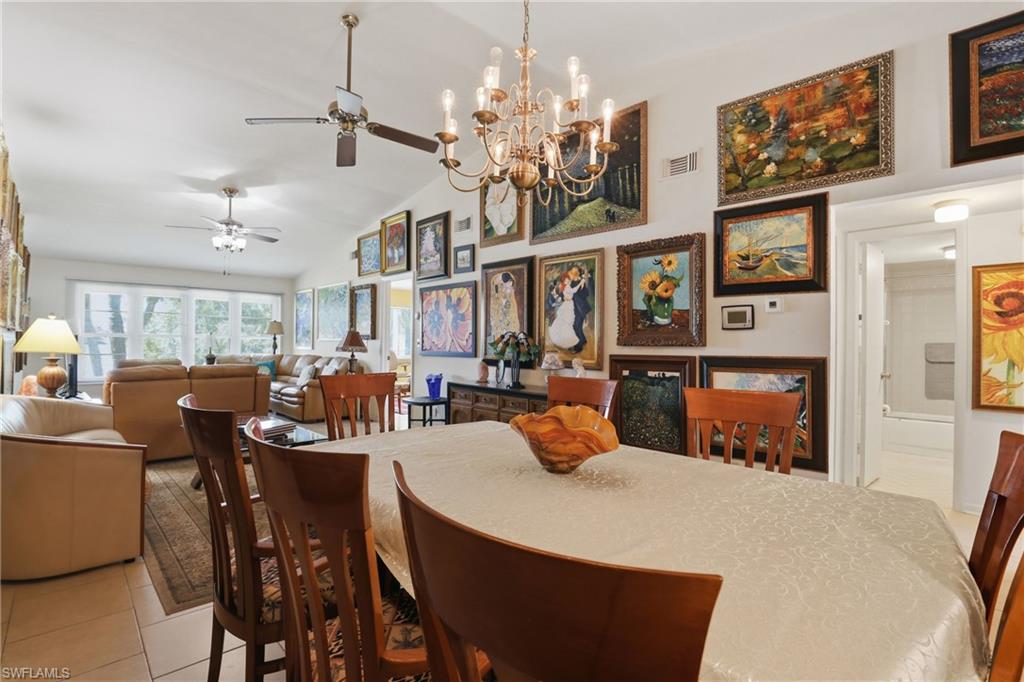 4050 Ice Castle Way, Unit 2812 Naples, FL 34112 - Photo 15 of 49 Open-concept dining area with vaulted ceilings and a brass-tone chandelier