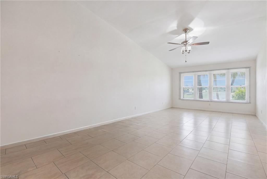 4050 Ice Castle Way, Unit 2812 Naples, FL 34112 - Photo 18 of 49 Spacious room featuring light-toned tile flooring, white baseboards, and a contemporary ceiling fan with integrated lighting