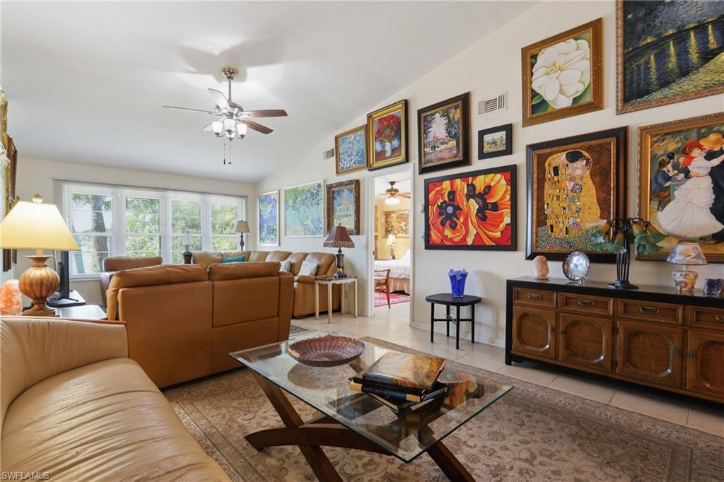 4050 Ice Castle Way, Unit 2812 Naples, FL 34112 - Photo 21 of 49 Spacious living area featuring a vaulted ceiling and an array of large windows
