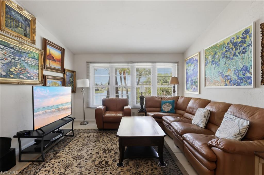 4050 Ice Castle Way, Unit 2812 Naples, FL 34112 - Photo 23 of 49 Living area featuring multiple pane windows, crown molding, and light-toned walls