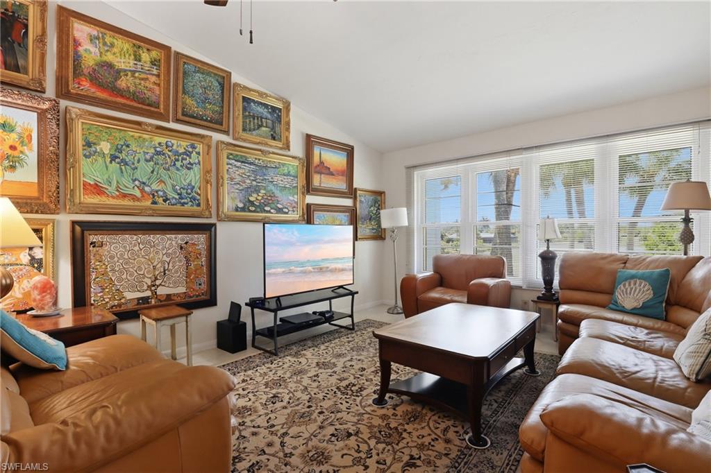 4050 Ice Castle Way, Unit 2812 Naples, FL 34112 - Photo 24 of 49 Spacious living area featuring a vaulted ceiling and large windows with horizontal blinds