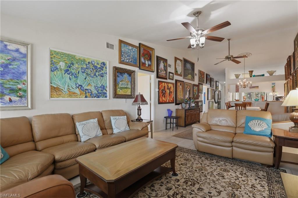 4050 Ice Castle Way, Unit 2812 Naples, FL 34112 - Photo 25 of 49 Open concept living area featuring light-toned walls and multiple ceiling fans