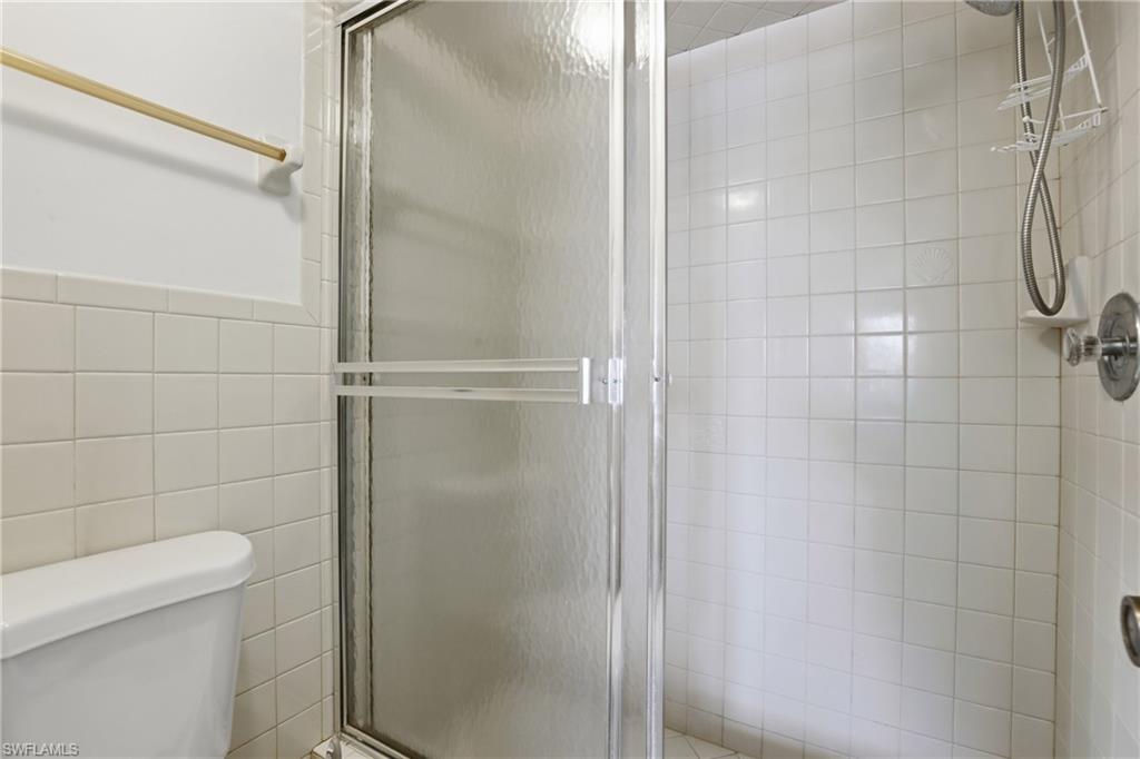 4050 Ice Castle Way, Unit 2812 Naples, FL 34112 - Photo 31 of 49 Glass-enclosed shower with white square tile walls and a chrome shower fixture
