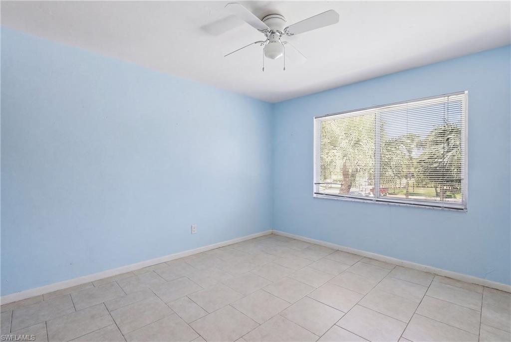 4050 Ice Castle Way, Unit 2812 Naples, FL 34112 - Photo 33 of 49 Spacious room featuring tile flooring, a wide window with horizontal blinds, and a ceiling fan with integrated lighting