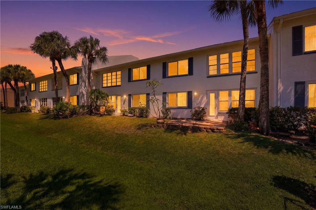 4050 Ice Castle Way, Unit 2812 Naples, FL 34112 - Photo 38 of 49 Multi-story white stucco exterior featuring multiple windows with dark shutters