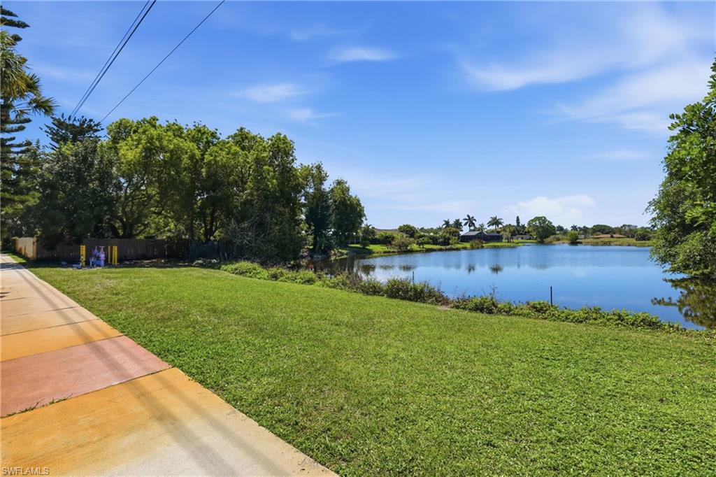4050 Ice Castle Way, Unit 2812 Naples, FL 34112 - Photo 41 of 49 Expansive waterfront property featuring a large body of water, mature trees, and a clear blue sky