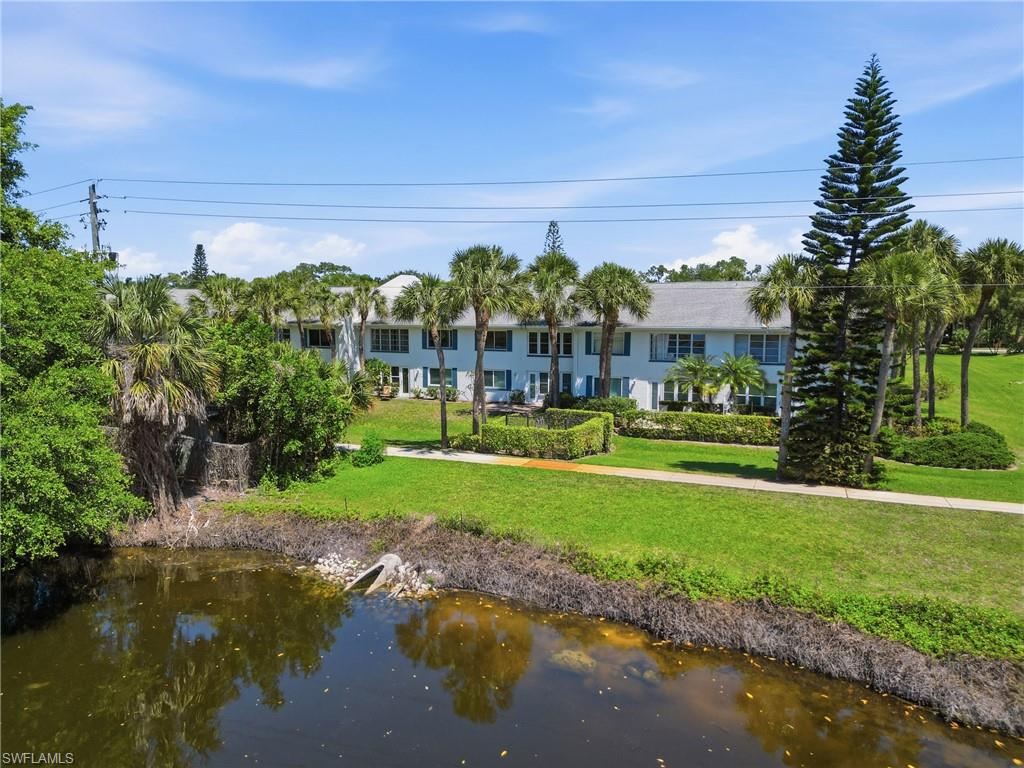 4050 Ice Castle Way, Unit 2812 Naples, FL 34112 - Photo 45 of 49 Two-story residential building with light blue siding, white trim, and dark blue shutters