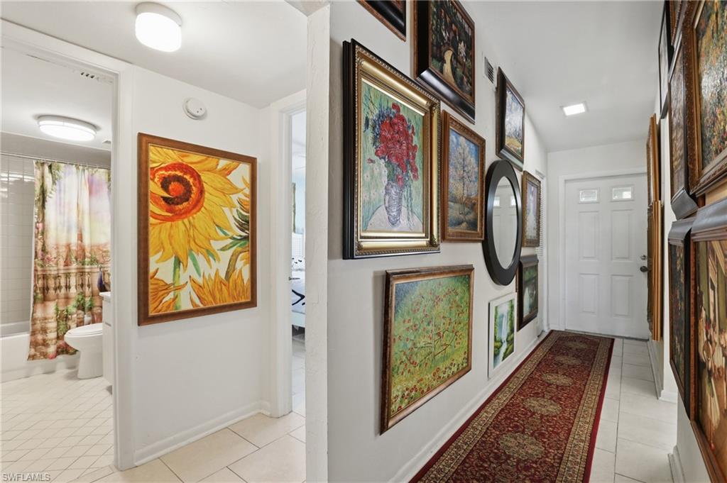 4050 Ice Castle Way, Unit 2812 Naples, FL 34112 - Photo 5 of 49 Hallway with white tile flooring and overhead lighting